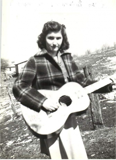 Hazel Dickens embodied a fearless honesty expressed in her singing, songwriting, and support of coal miners and women. She never lost her West Virginia mountain vocal style despite her success as an artist and feminist icon. Her life began to change when she met Mike Seeger of the New Lost City Ramblers. Seeger introduced Hazel not only to the folk music scene but to Alice Gerrard. The two blended beautifully musically, and they began a then unheard of female bluegrass duo. Beginning in 1965, they recorded two seminal albums for Folkways with two more released by Rounder during the early 1970s. A fifth album, compiled from practice tapes, appeared in 2018. They also recorded with the mixed gender group, the Strange Creek Singers. During this time, Hazel’s songwriting began to develop alongside her sense of social justice. Gaining courage to sing her new material in jam sessions, her first expression of concern for women’s issues came with “Don’t Put Her Down, You Put Her There.” She was the subject of Mimi Pickering’s Appalshop film “It’s Hard to Tell the Singer from the Song”. The University of Illinois press in 2008 published “Working Girl Blues: The Life and Music of Hazel Dickens”, co-written by Hazel and historian Bill Malone. In 2001, she received the National Heritage Fellowship from the National Endowment for the Arts. In 2017 Hazel and Alice were inducted into the Bluegrass Music Hall of Fame, fifteen years after they received the Folk Alliance Lifetime Achievement Award.