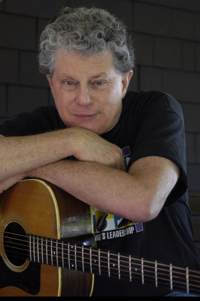 Si Kahn, born April 23, 1944, is an American singer-songwriter, activist, and founder and former executive director of Grassroots Leadership. Most of the profits from Kahn's musical performances benefit this group. His grandfather, mother, and his father instilled a strong sense of the family's Jewish heritage as well as teaching him the rudiments of rhythm and harmony as a child. Kahn earned a bachelor's degree from Harvard University. In 1995 he completed a Ph.D. in American Studies from the Union Institute. Kahn moved to the south as an activist in the Civil Rights Movement, and he now lives in Charlotte, North Carolina. Though Kahn writes songs about a variety of topics, he is especially known for songs about workers and their families, like "Aragon Mill" (1974). He frequently writes songs, and occasionally performs, with singer-songwriter and multi-instrumentalist John McCutcheon. Kahn usually accompanies himself on a steel-string acoustic guitar, played with brass fingerpicks.