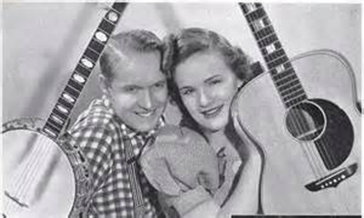 Scott Greene Wiseman was born November 8th, 1909 on a farm in the mountains of Western North Carolina. His interest in music went as far back as his mother teaching him to sing when he was just able to walk. In 1927, Scotty graduated from Crossnore as class president. Scotty went on to Duke University. Unfortunately, financial hardships caused Scotty to only complete one year at Duke University. A short time after this, Scotty was introduced to radio. The year was 1929 and radio was still in its infancy. It was at this time that Scotty coined his radio name as “Skyland Scotty” and the name immediately took to his listeners. From WMMN, Scotty went on to station WLS-AM in Chicago, Illinois. WLS-AM’s National Barn Dance was a rival to WSM-AM’s Grand Ole Opry. Here, Scotty met his love, Myrtle Eleanor Cooper. They married on December 13th, 1934 and had regular appearances on National Barn Dance on WLS-AM Chicago. They performed under the stage name “Lulu Belle and Scotty”, “Sweethearts of Country Music”. Lulu Belle and Scotty were best known for their classic song “Have I Told You Lately That I Love You?”. This became one of the first country songs to attract major attention in pop circles and was recorded by artists in both genres. Lulu Belle and Scotty also ventured into featured motion pictures. The couple retired in 1958 Scotty Wiseman was inducted into the Nashville Songwriters Hall of Fame in 1971. Scotty Wiseman passed away in 1981 and Lulu Belle in 1999.